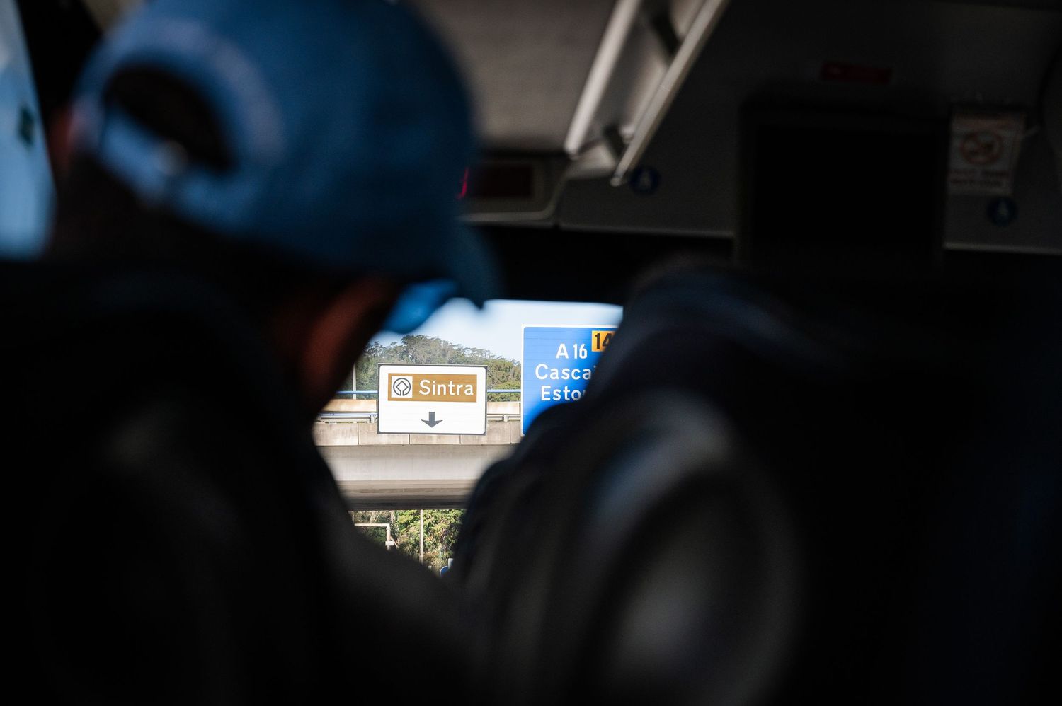 View from inside a vehicle of a highway road sign in Portugal through the window.