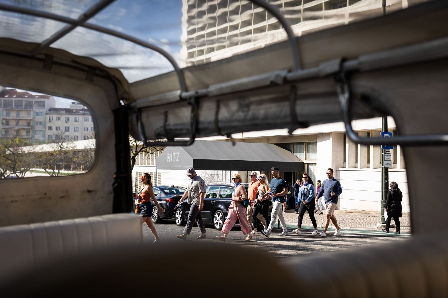 Group of people walking through an urban underpass tunnel on a bright sunny day in the city.