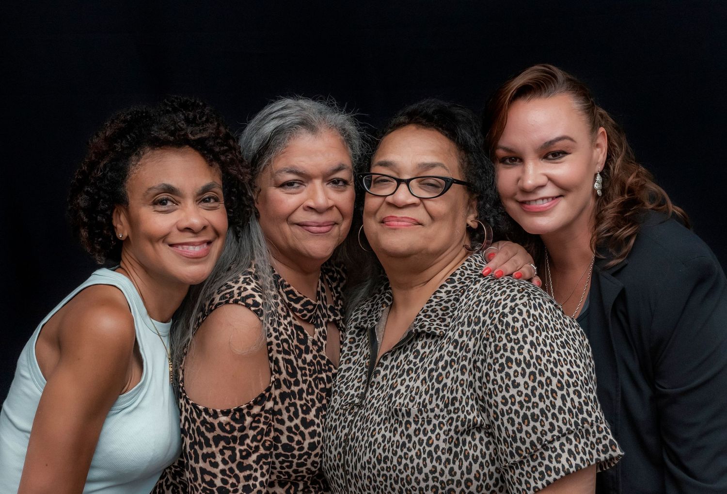 Four women posing for a portrait at a 60th birthday party and smiling in Montclair, NJ