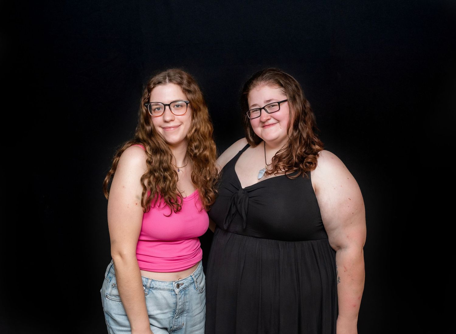 Two women pose for a portrait and smile at a college graduation party in Hewitt, NJ