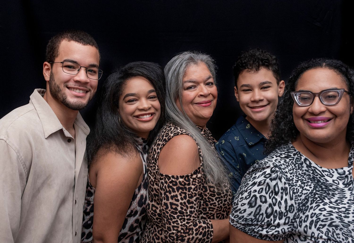 Five people celebrating a 60th birthday party in Montclair, NJ, posing for a portrait capturing joyful smiles