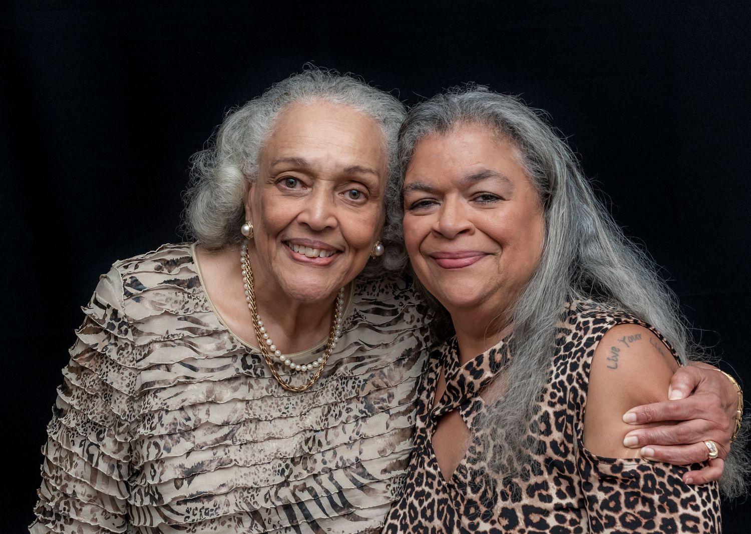 Two women posing for a portrait at a 60th birthday party and smiling in Montclair, NJ