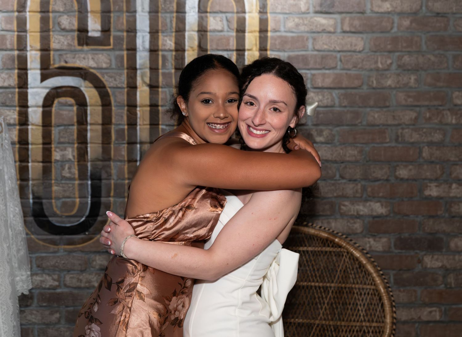 Two women posing together and hugging at a bridal shower celebration in Freehold, NJ