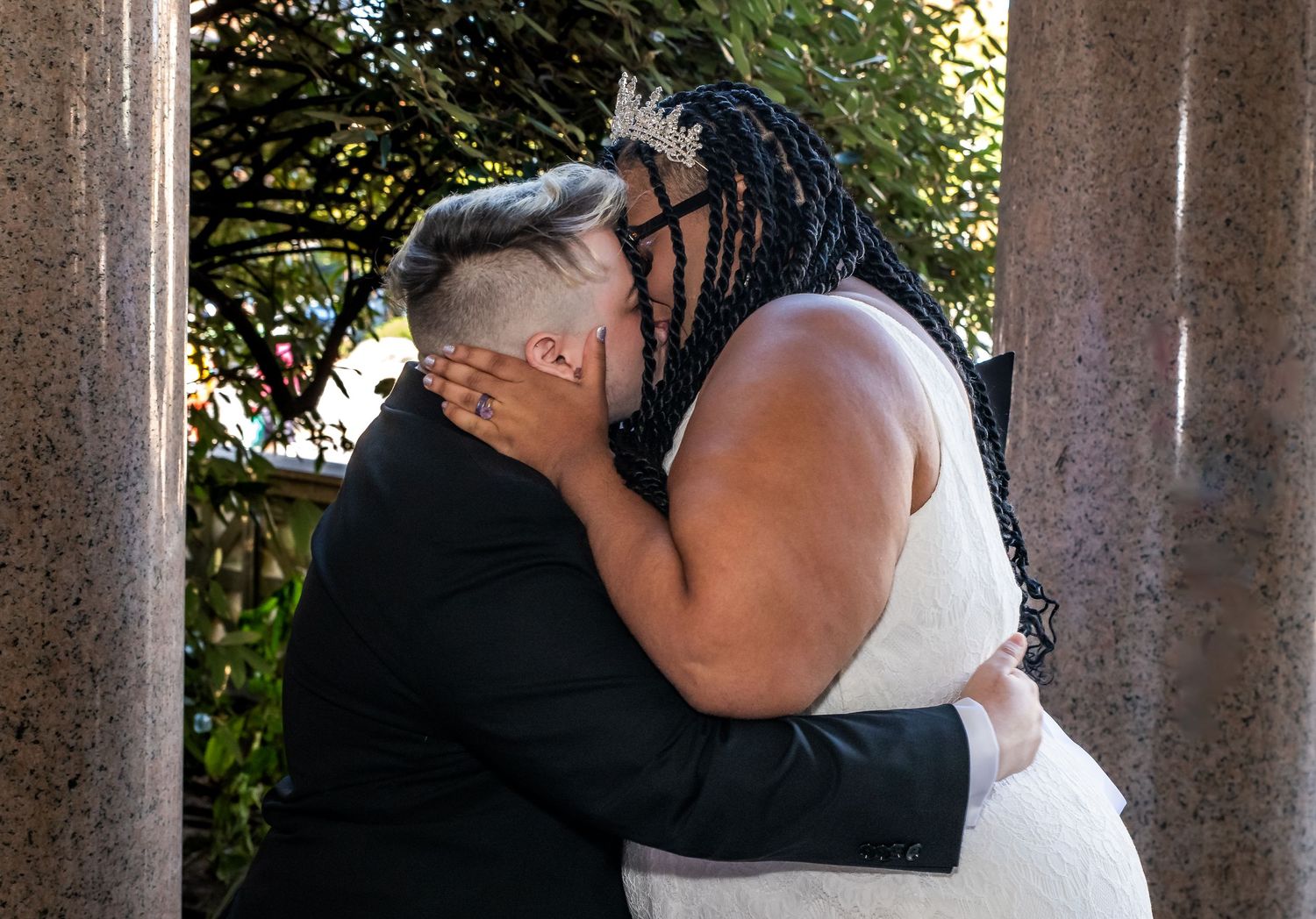 A couple kisses after being married in a gazebo in Brooklyn, NY