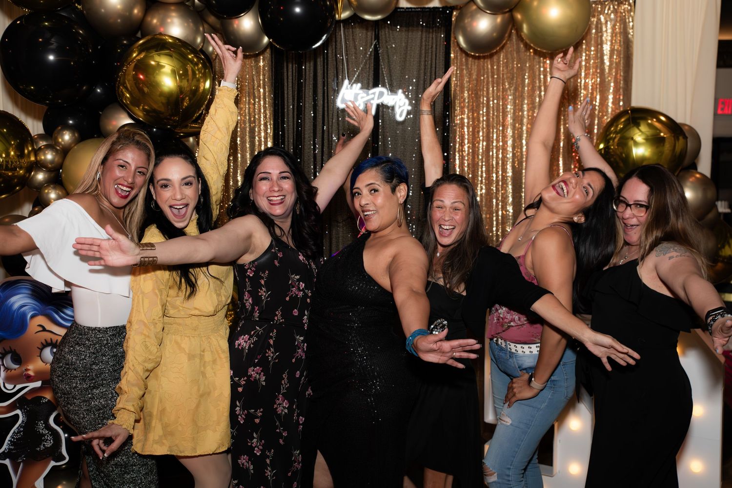 Seven women at a 50th birthday party in Rutherford, NJ, having fun and posing for a photo