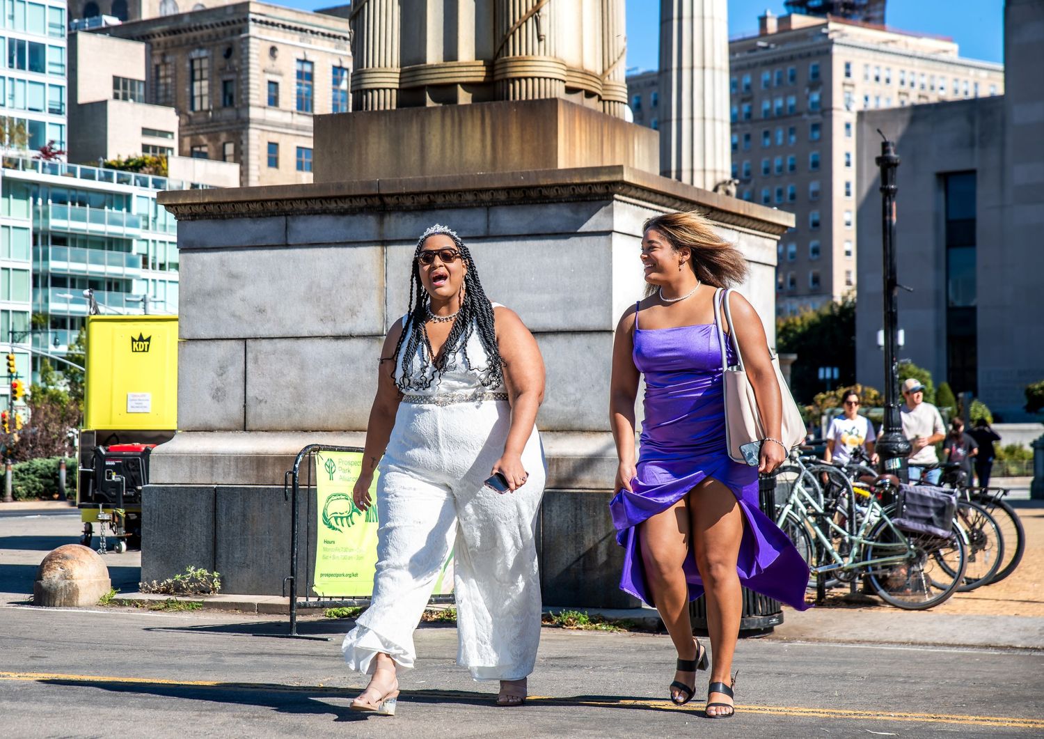 Two people walking towards the place that one will get married in and they are crossing the street and smiling in Brooklyn, NY