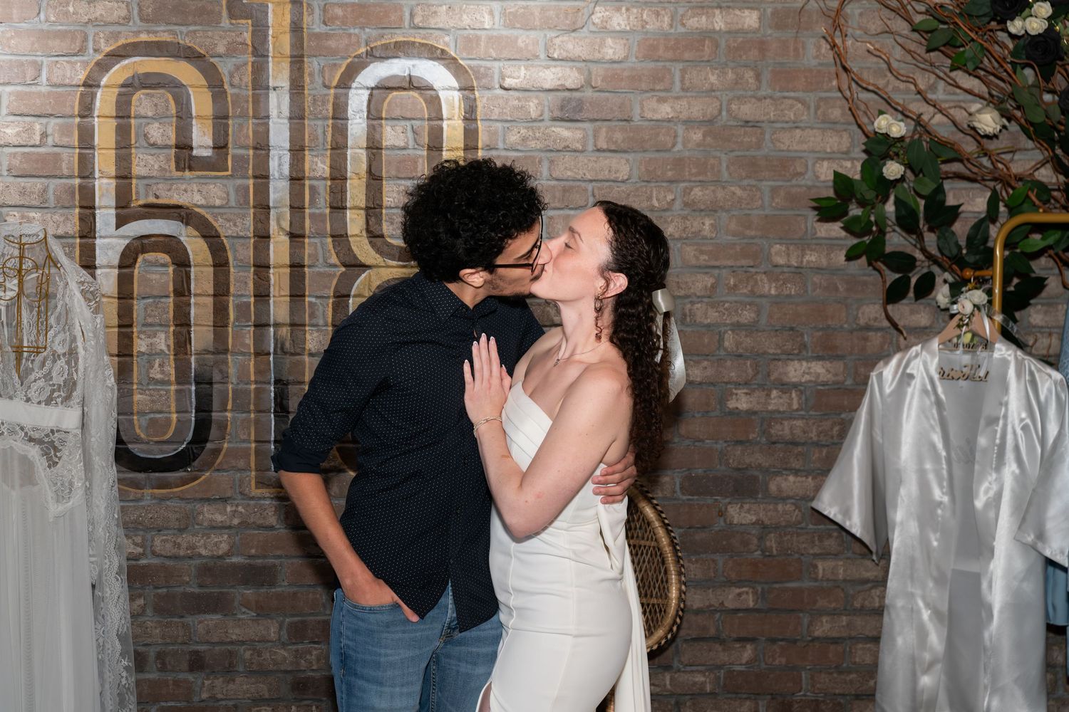 The bride to be and her fiancé share a kiss for the camera at a bridal shower in Freehold, NJ