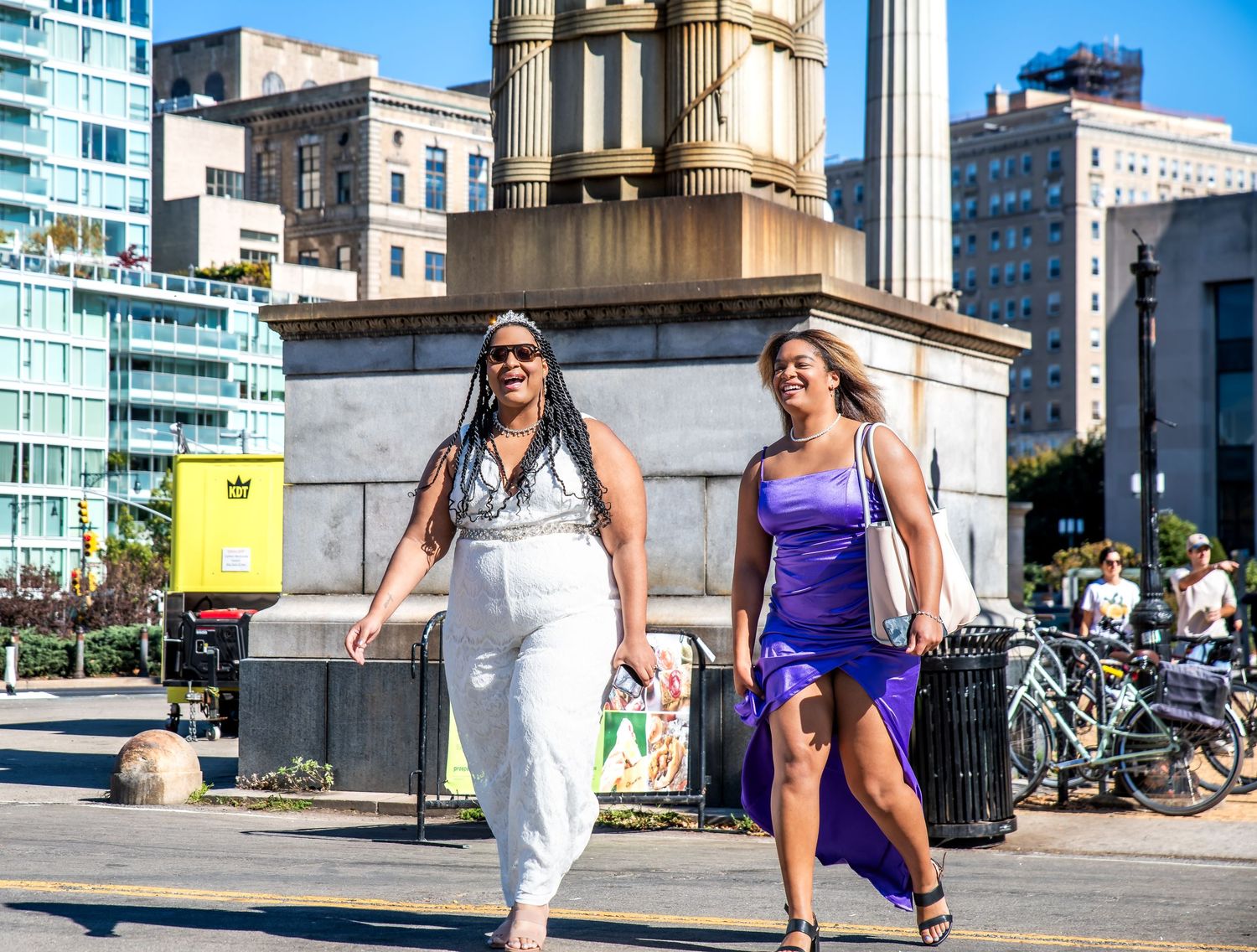 Two people walking towards the place that one will get married in and they are crossing the street and smiling in Brooklyn, NY