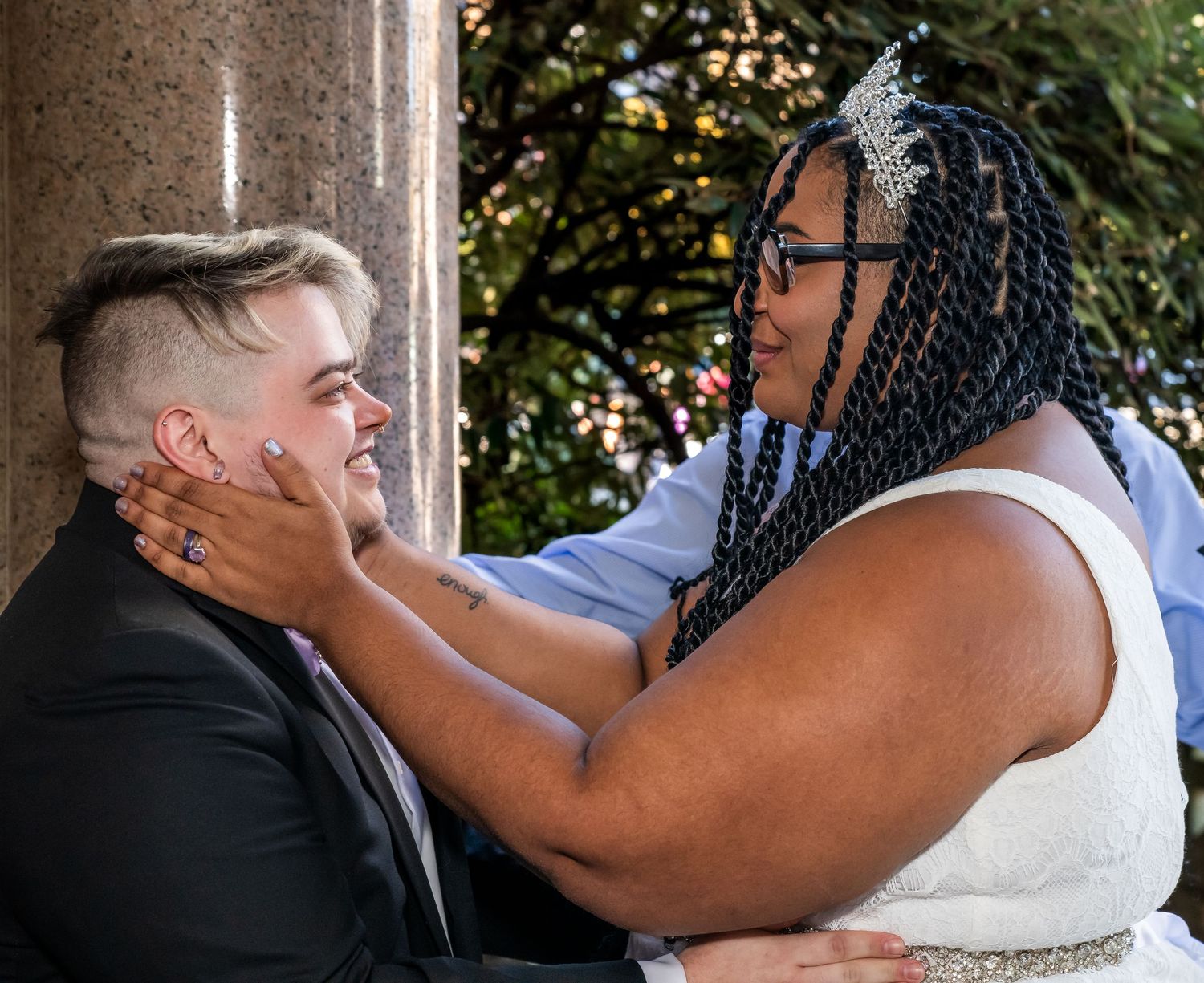 Two people getting married in Brooklyn, NY, while one is holding the others face lovingly in her hands