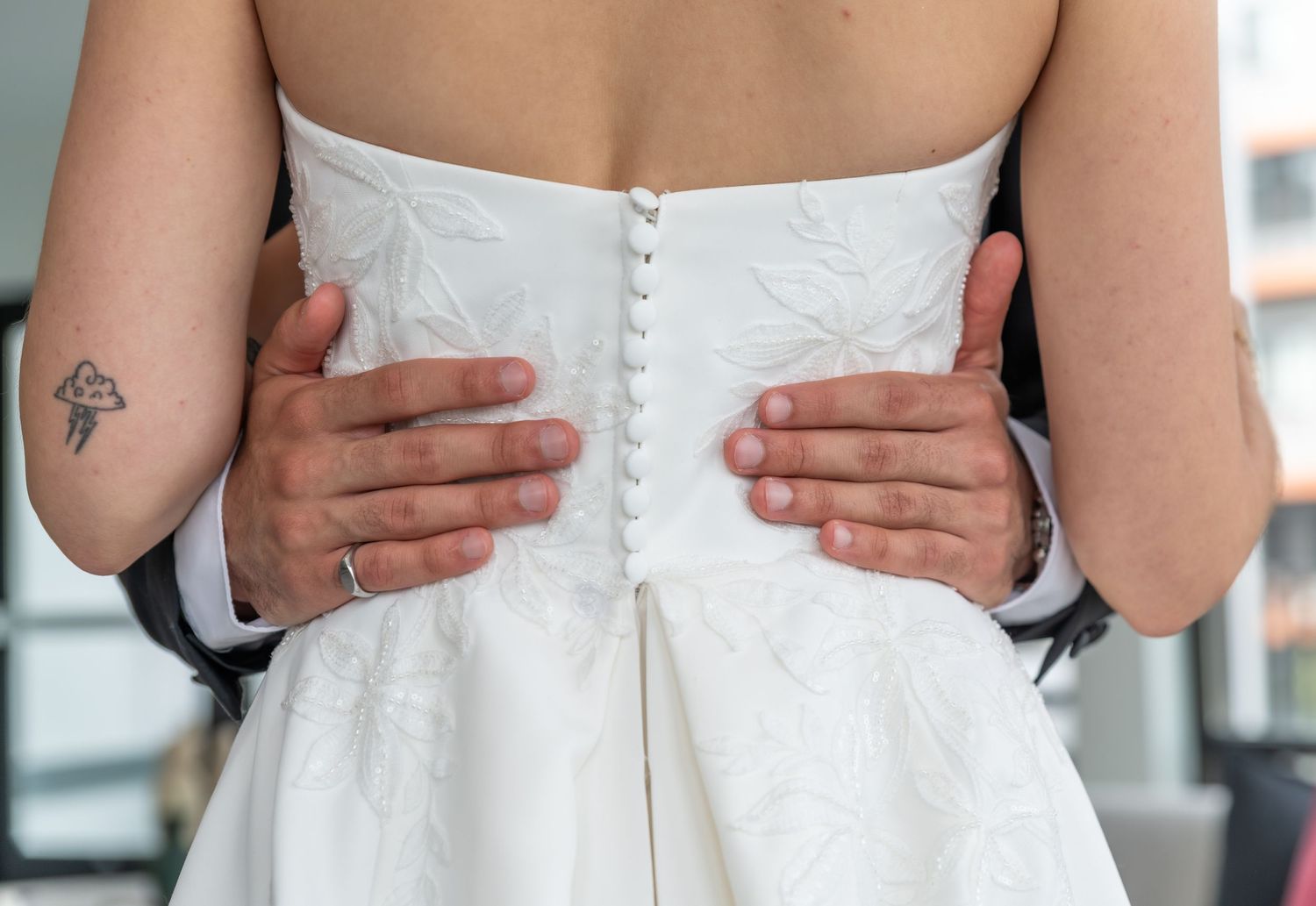 a close-up photo of the groom's hands around the bride's waste in Bayonne, NJ