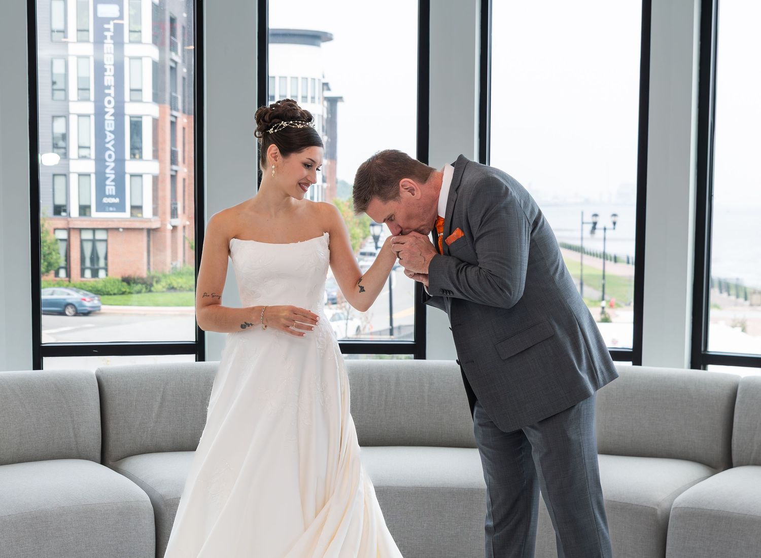 The bride's father is kissing her hand after the first look together in Bayonne, NJ