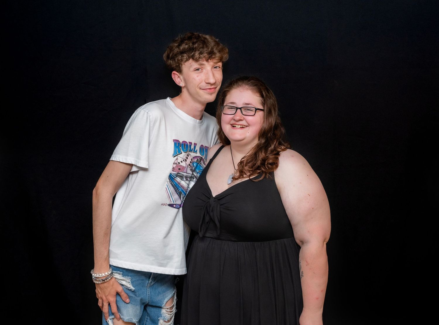 A man and a woman pose for a portrait and smile at a college graduation party in Hewitt, NJ
