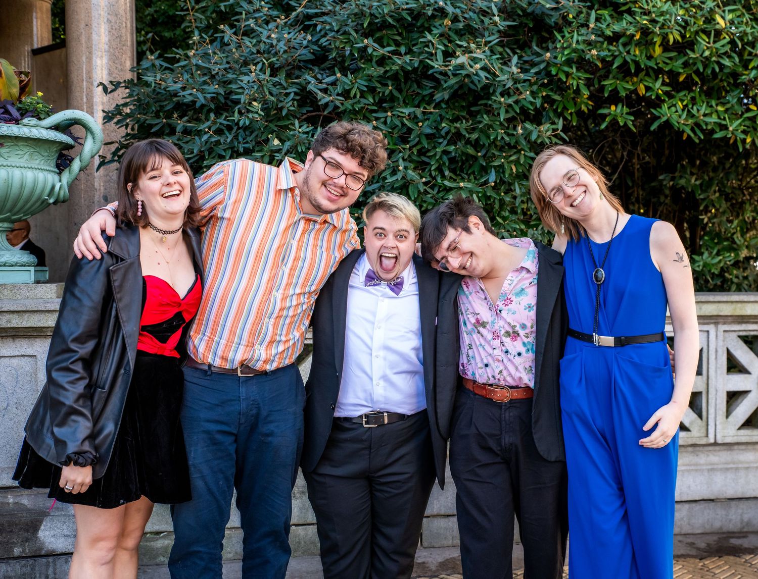 A group photo of five people of the groom with a silly face and friends after the ceremony in Brooklyn, NY
