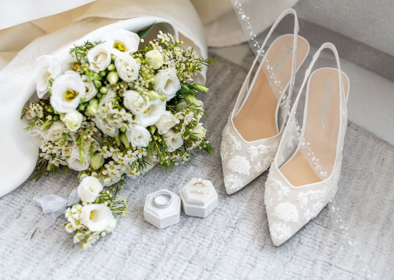A detail photo of the bride's shoes, the wedding rings and the bouquet in Bayonne, NJ