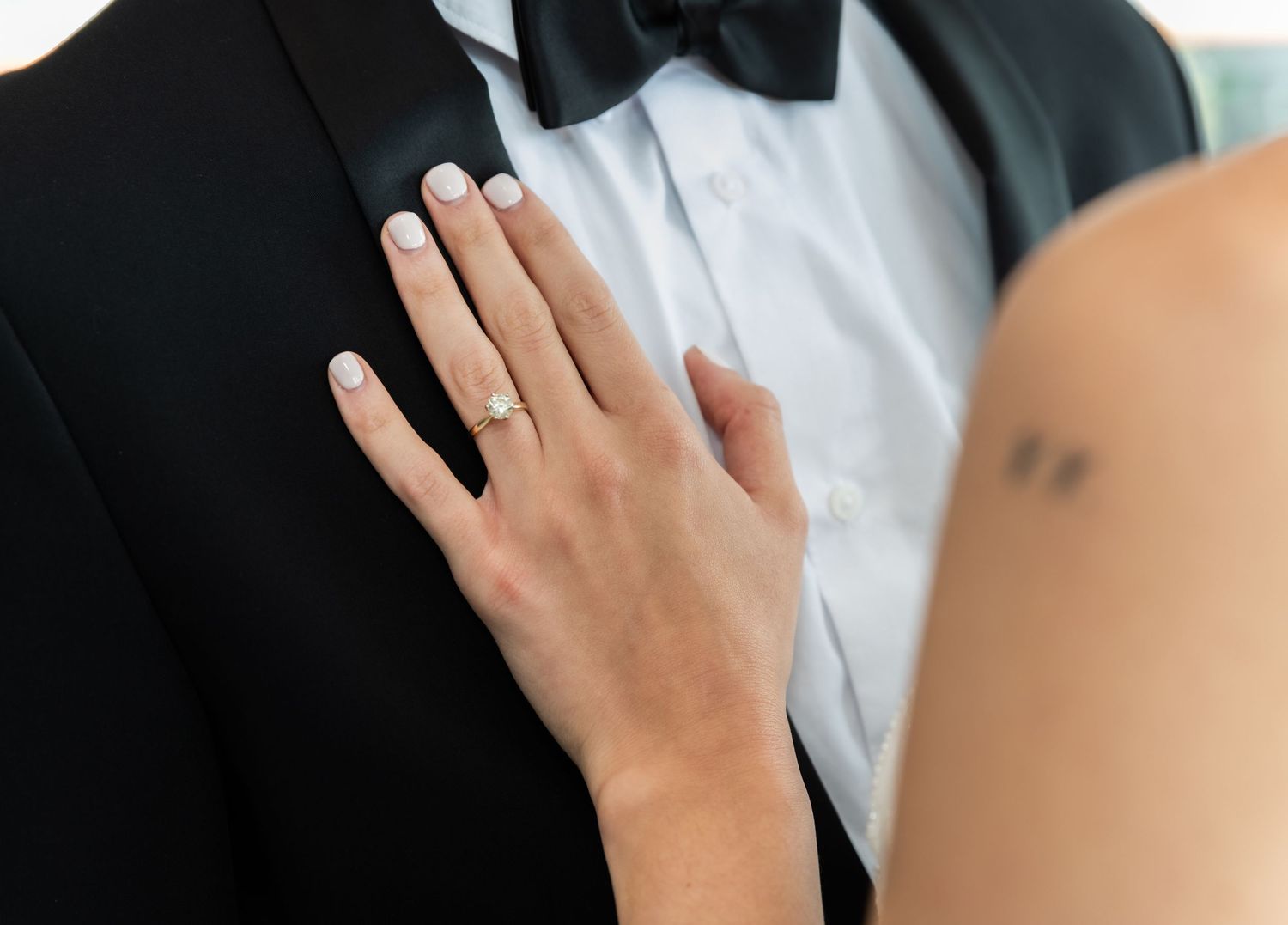 A close-up of the bride's hand on the groom's chest showing the engagement ring in Bayonne, NJ