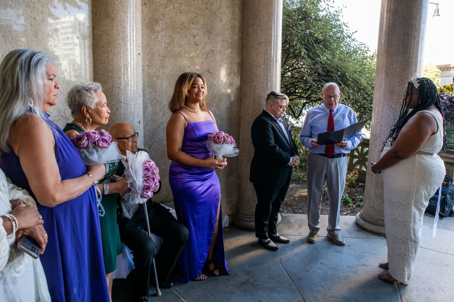 A group of people witnessing two people getting married in a gazebo in Brooklyn, NY