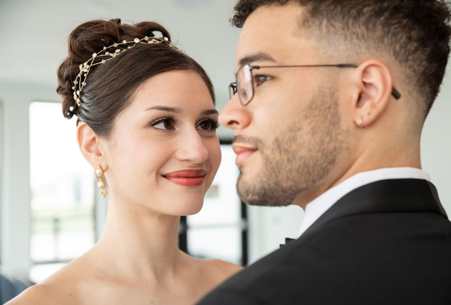 A portrait of a bride and groom as the bride is looking at the groom as he is looking away in Bayonne, NJ