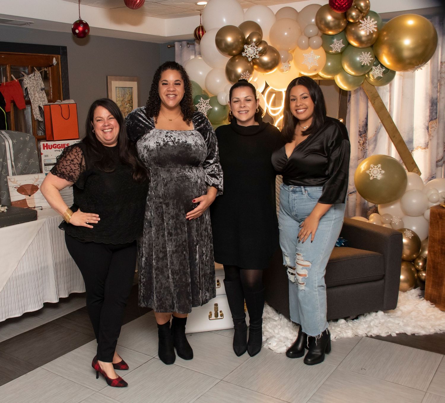 Four women posing at a bridal shower, smiling with the mom to be in Rutherfod, NJ