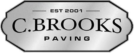 C. Brooks Paving logo established 2001, featuring elegant silver metallic badge design.