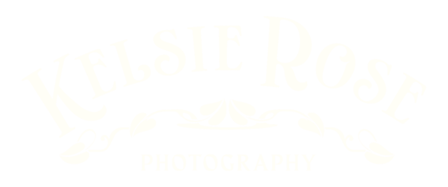 Elegant white script logo with decorative flourishes on a white background.