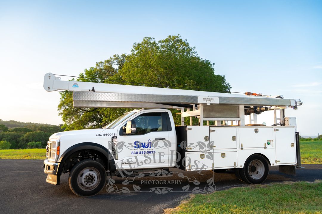 Saul Water Well Service branded white company truck parked on paved rural Texas road.