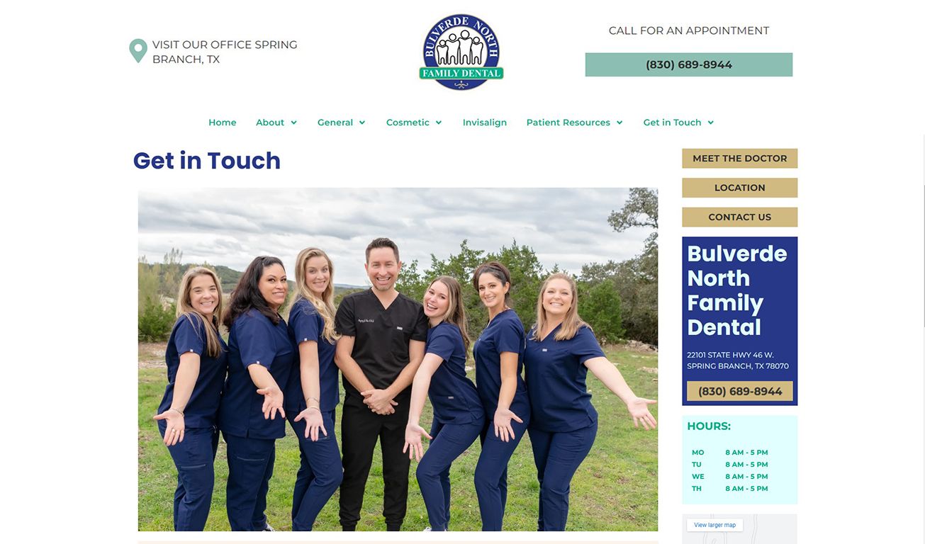 Dental team at Bulverde North Family Dental in Spring Branch, TX smiling outdoors in navy scrubs.