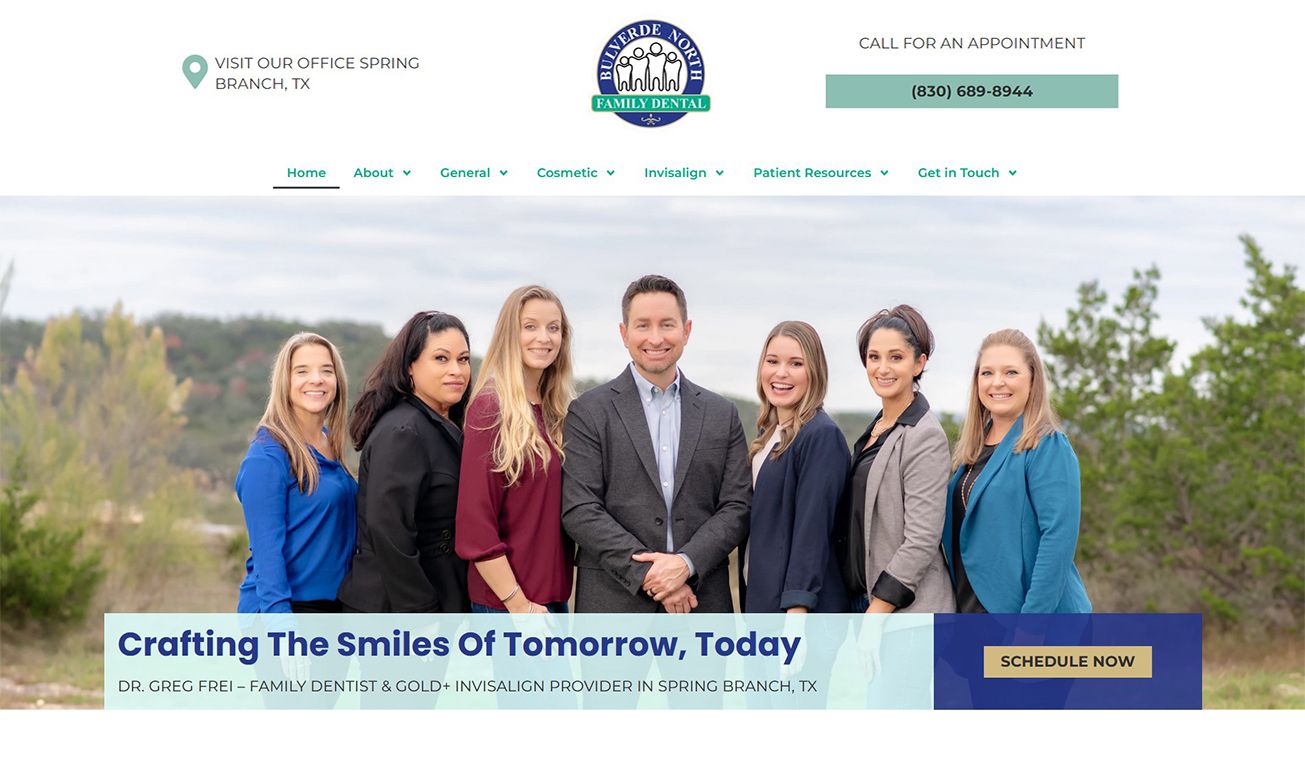 A dental team of seven professionals posing outdoors at Bulverde North Family Dental in Spring Branch, TX.
