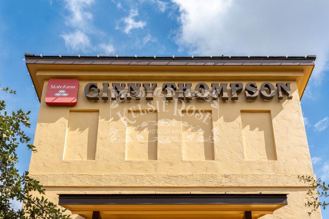 Ginny Thompson State Farm insurance office exterior sign on yellow stucco building facade.