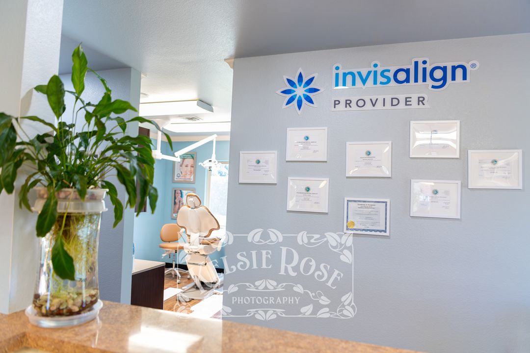 Invisalign provider dental office reception area with awards and certificates on wall.