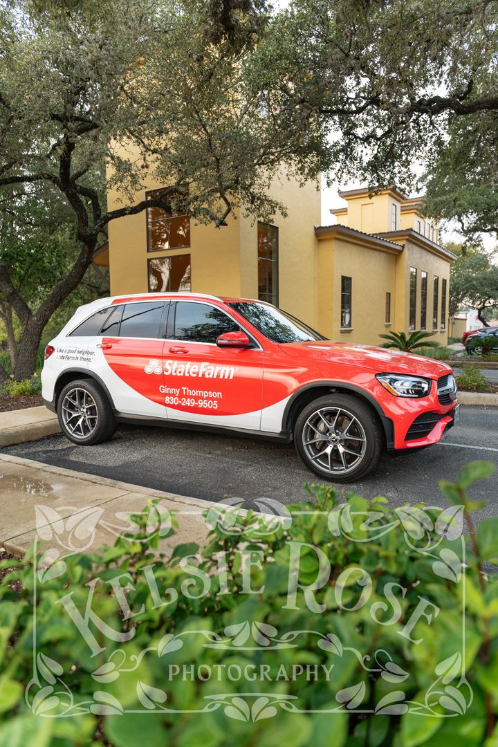 Red State Farm branded Mercedes SUV parked outside Ginny Thompson insurance office building.
