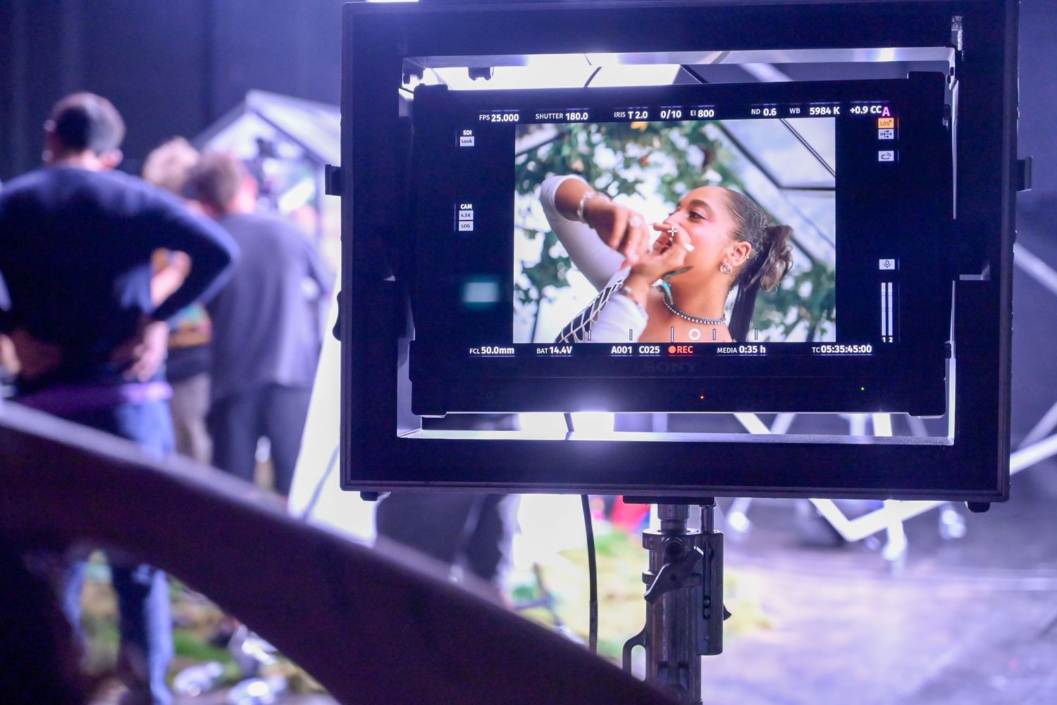 Camera monitor displays showing live footage during video production.