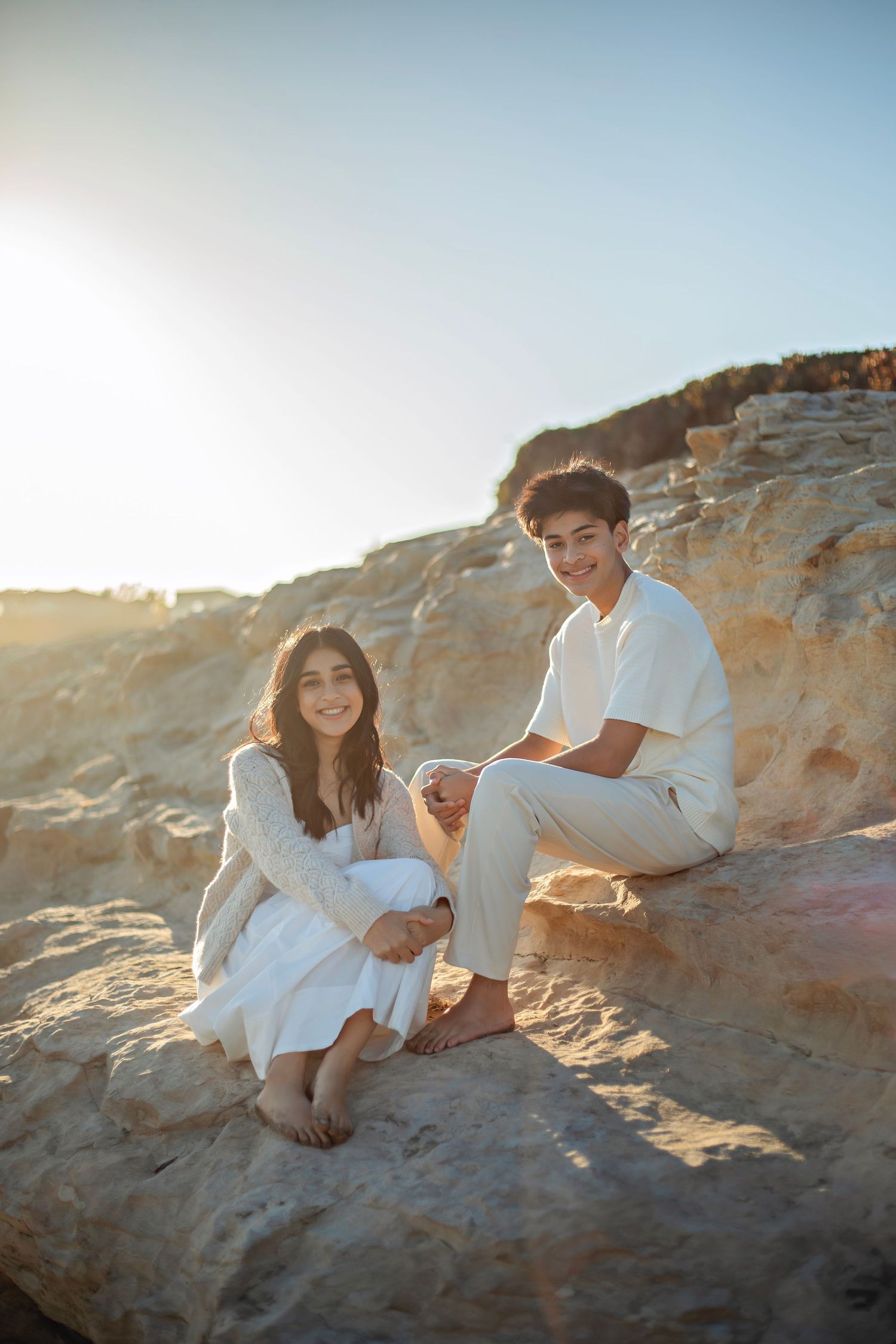 Siblings enjoying a beach in Santa Cruz, captured in natural light with candid moments, ocean views, and a relaxed coastal setting