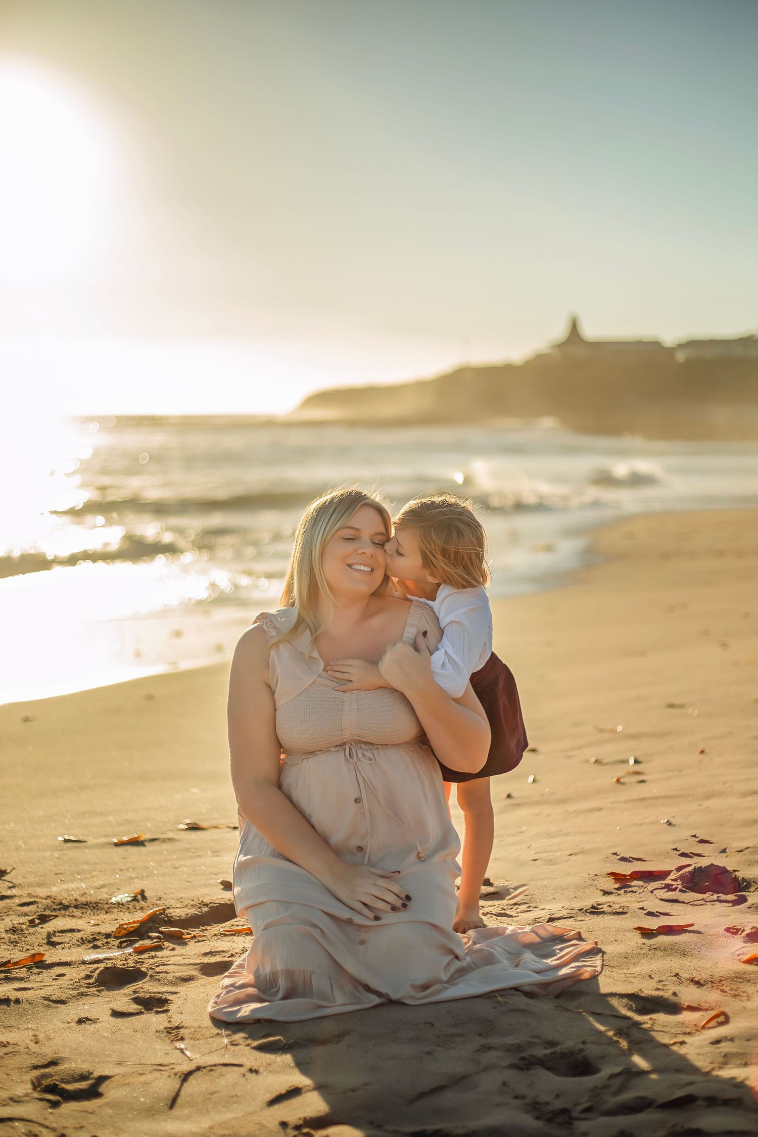 Family maternity photo session at a Santa Cruz beach, candid moments, ocean views, and a warm, relaxed coastal atmosphere.