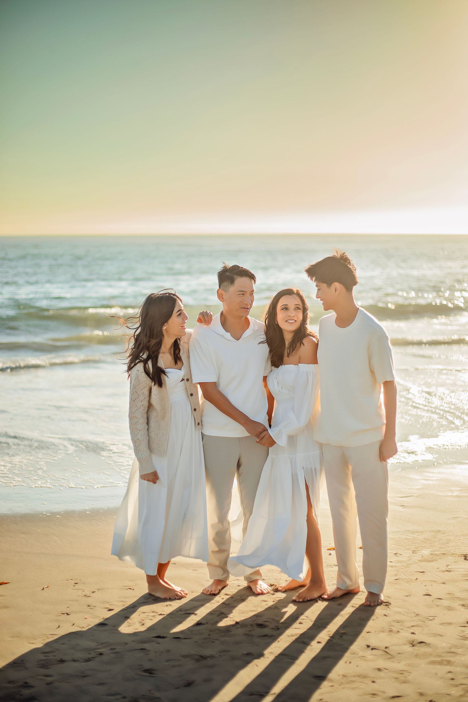 Family enjoying at the beach in Santa Cruz, captured in natural light with candid moments, ocean views, and a relaxed coastal setting