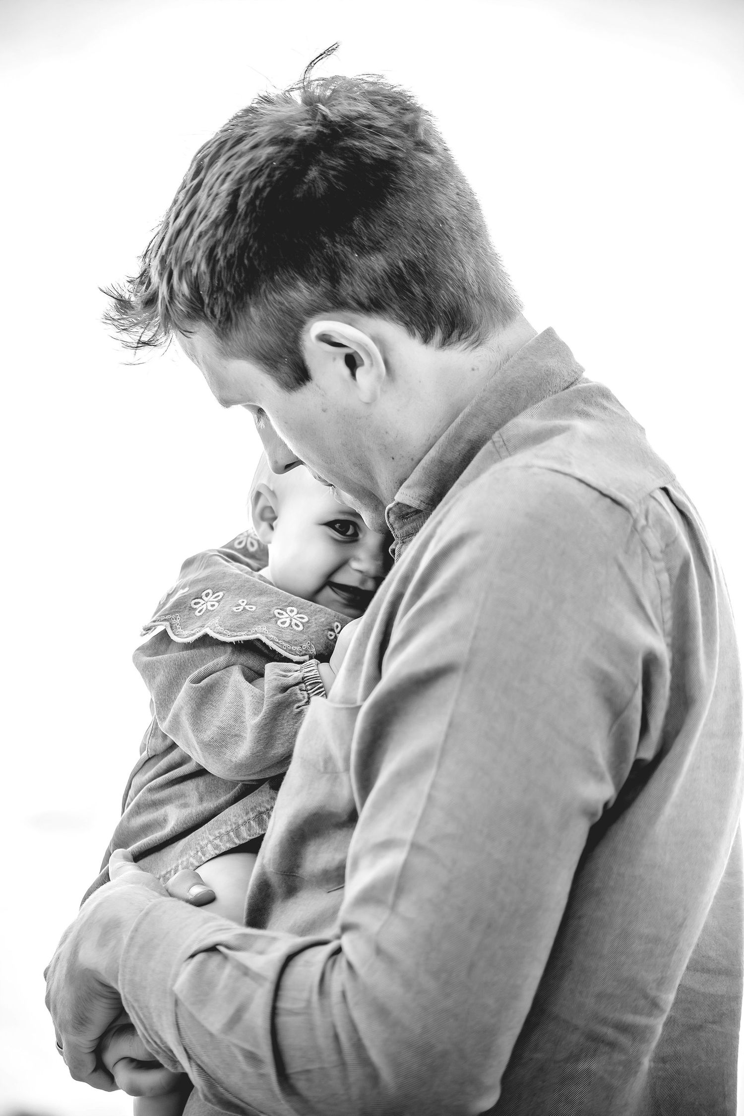 A father and baby enjoying a beach in Santa Cruz, captured in natural light with candid moments, ocean views, and a relaxed coastal setting