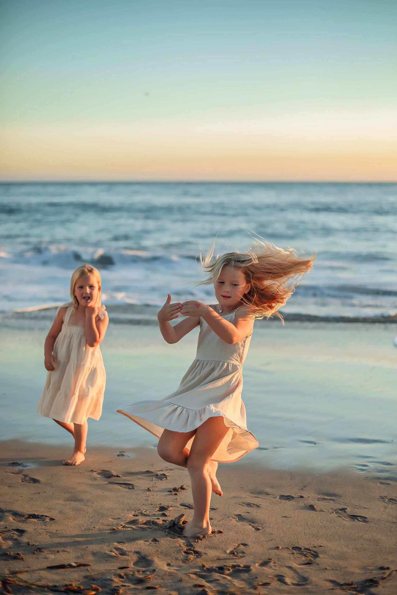 Children playing at the beach in Santa Cruz during golden hour, captured in natural light with candid, joyful moments and coastal scenery.