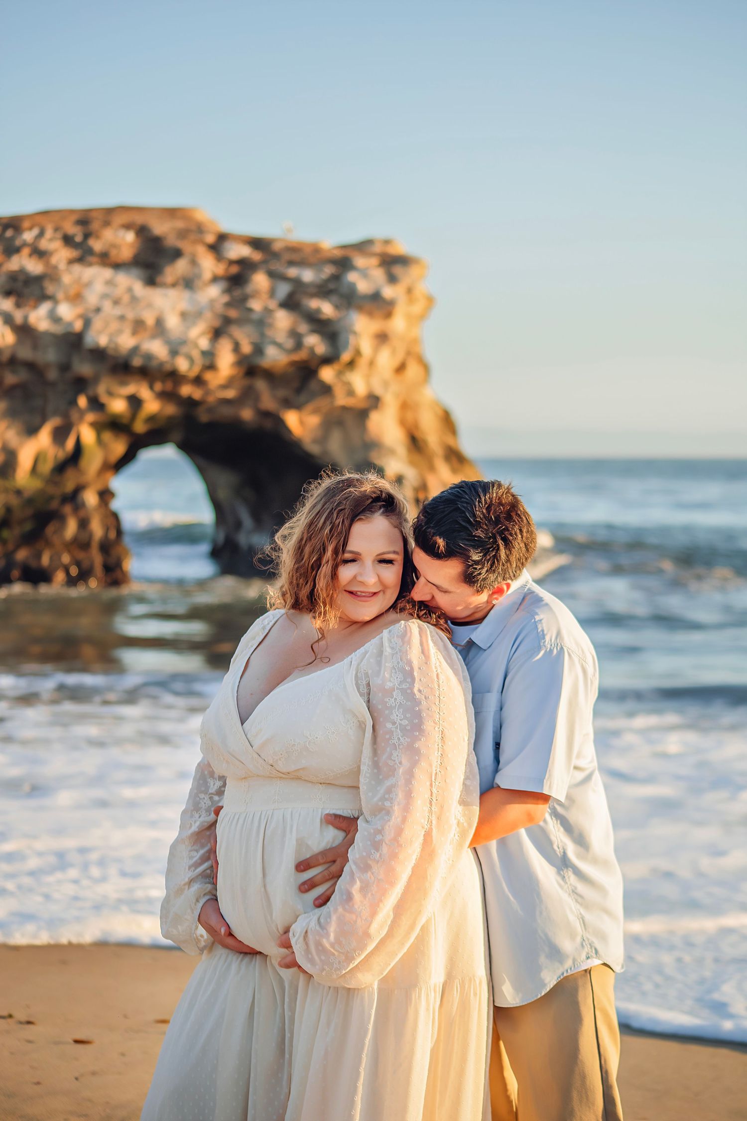 Family maternity photo session at a Santa Cruz beach, candid moments, ocean views, and a warm, relaxed coastal atmosphere.