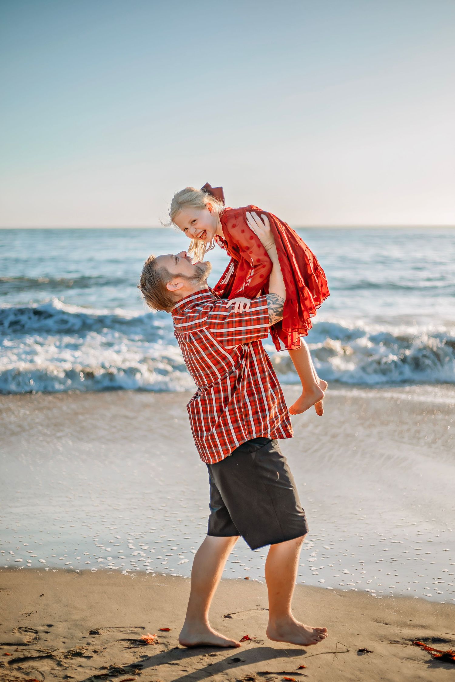 A Father & daughter enjoying at the beach in Santa Cruz, candid moments, ocean views, and a relaxed coastal setting