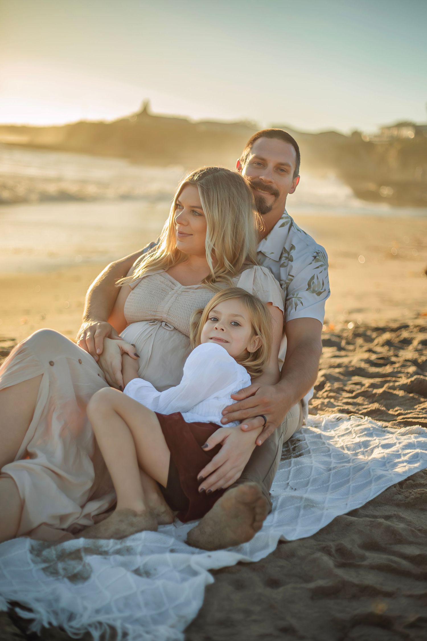 Family maternity photo session at a Santa Cruz beach, candid moments, ocean views, and a warm, relaxed coastal atmosphere.