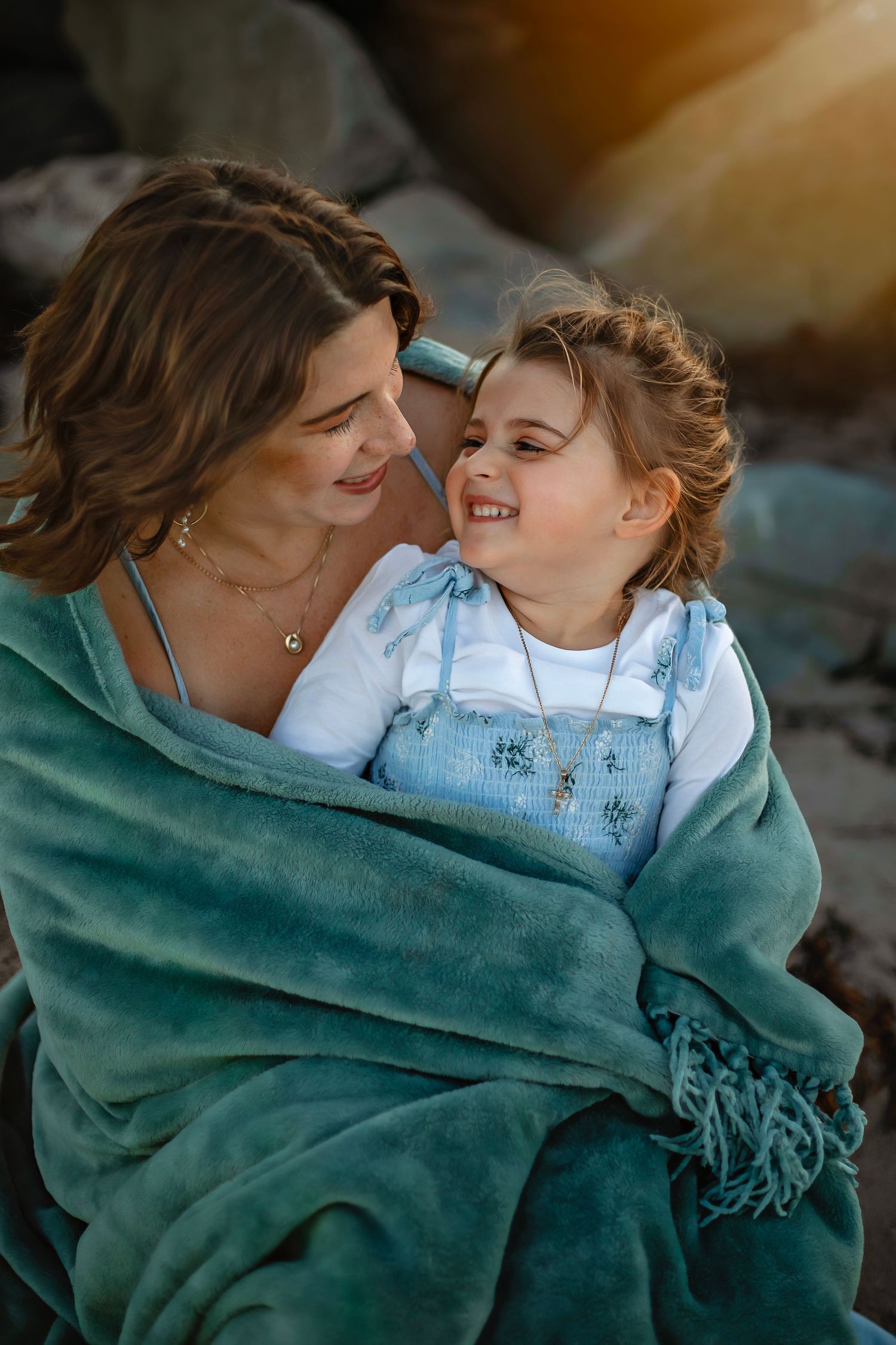 A mother and kid enjoying a beach in Santa Cruz, captured in natural light with candid moments, ocean views, and a relaxed coastal setting