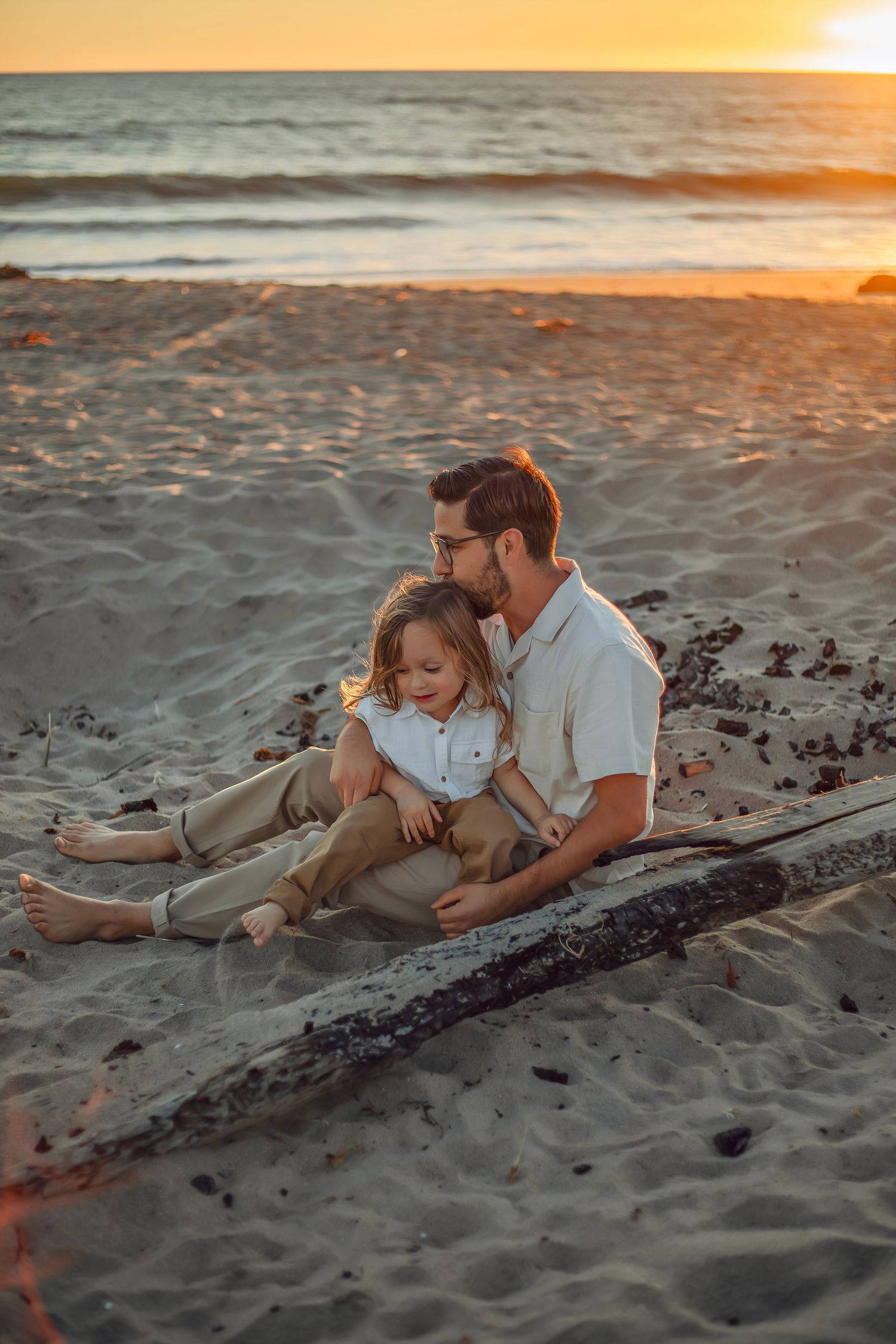 A father and son enjoying a beach in Santa Cruz, captured in natural light with candid moments, ocean views, and a relaxed coastal setting