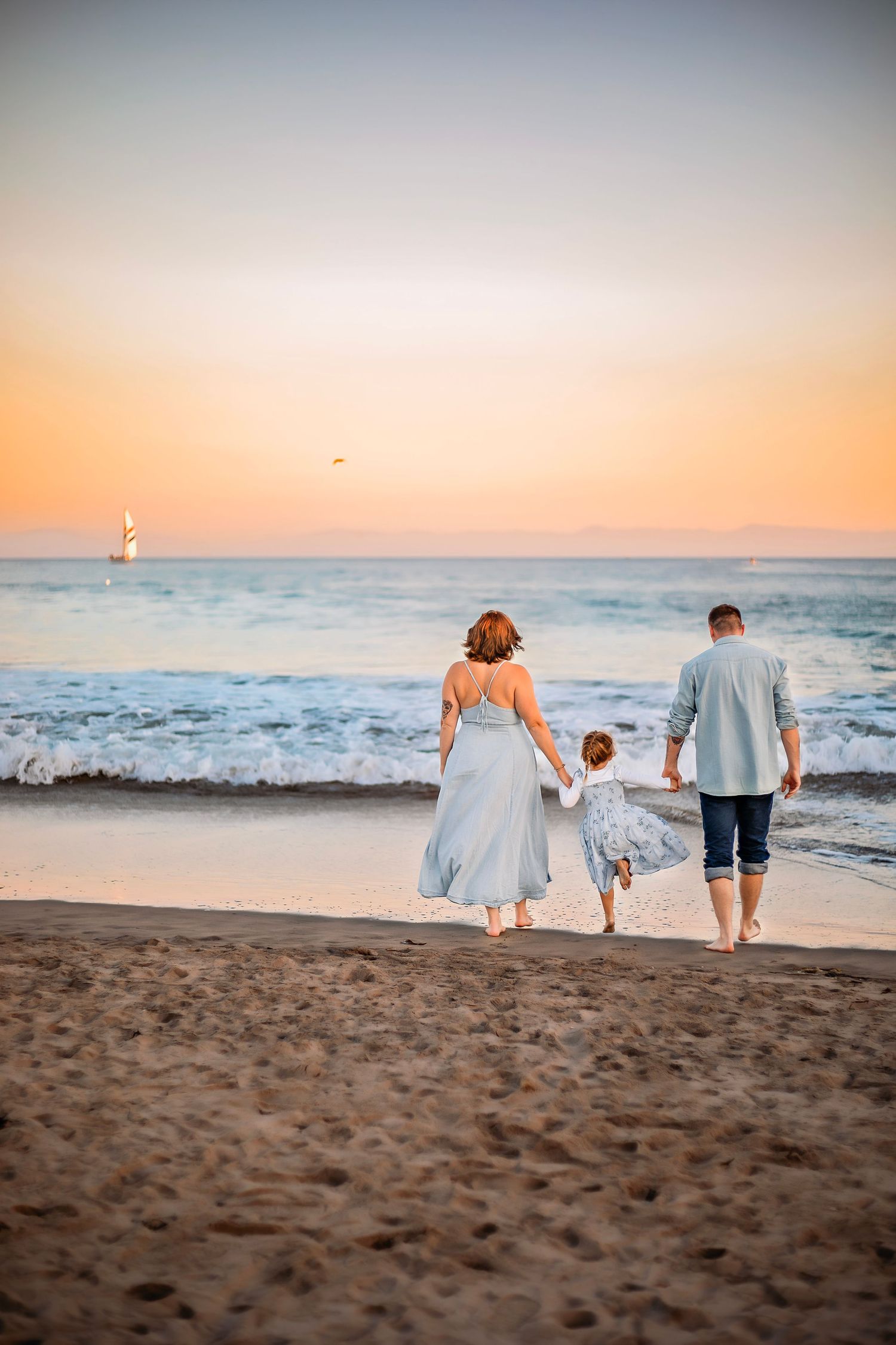 Family enjoying at the beach in Santa Cruz, captured in natural light with candid moments, ocean views, and a relaxed coastal setting