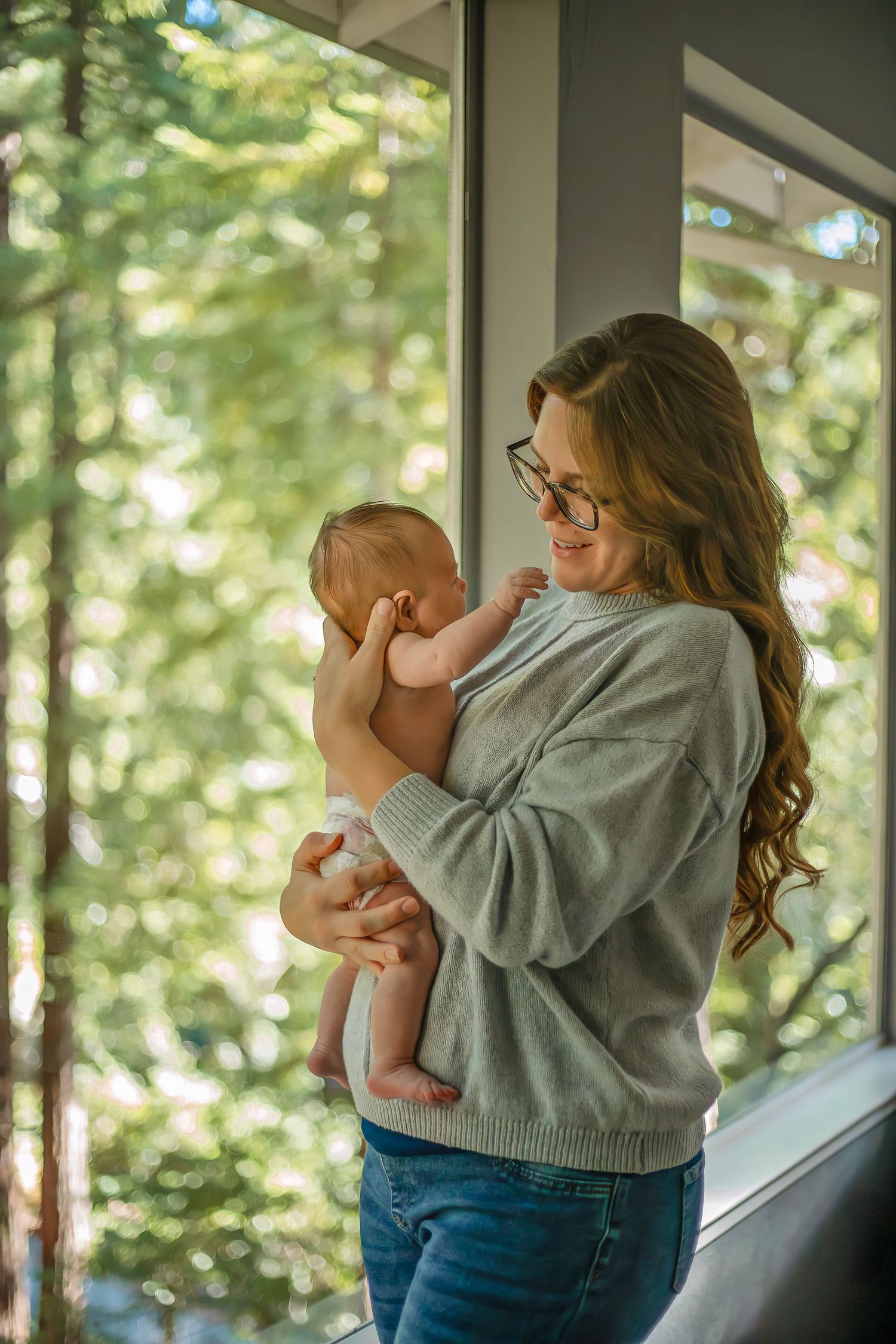 At-home newborn photo session in Santa Cruz, capturing a family’s intimate, candid moments with warmth and heartfelt connection