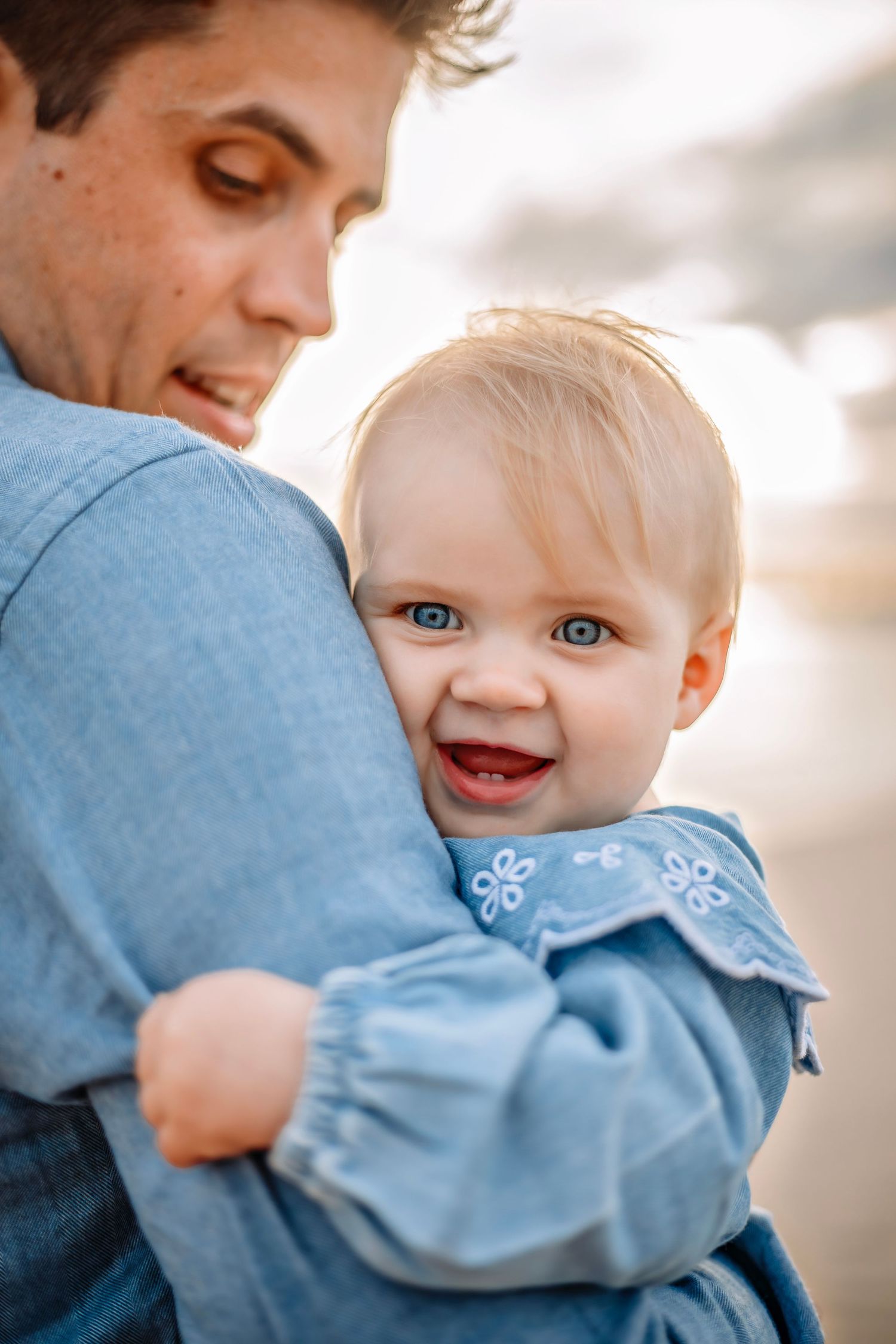 A father and baby enjoying a beach in Santa Cruz, captured in natural light with candid moments, ocean views, and a relaxed coastal setting
