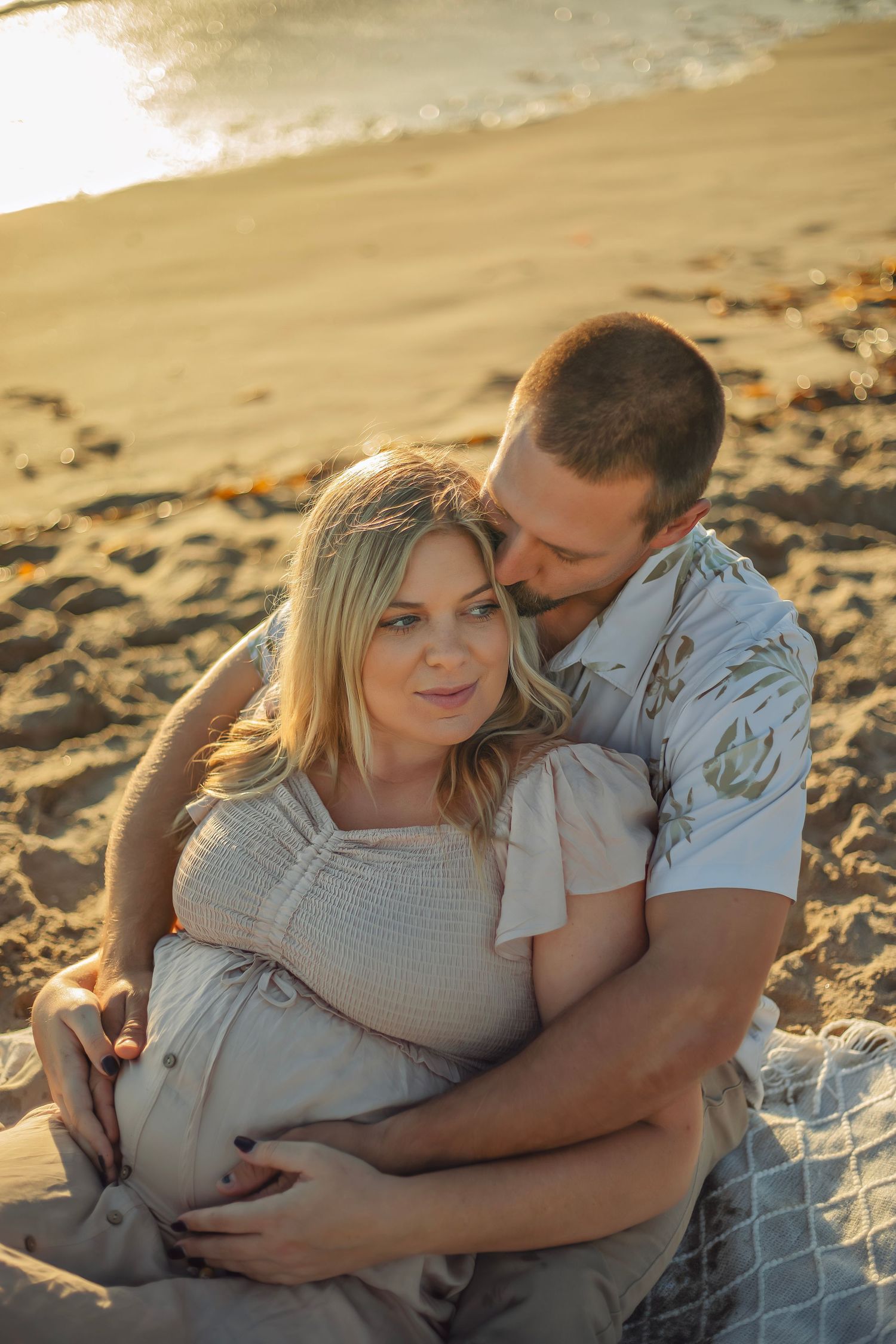 Family maternity photo session at a Santa Cruz beach, candid moments, ocean views, and a warm, relaxed coastal atmosphere.