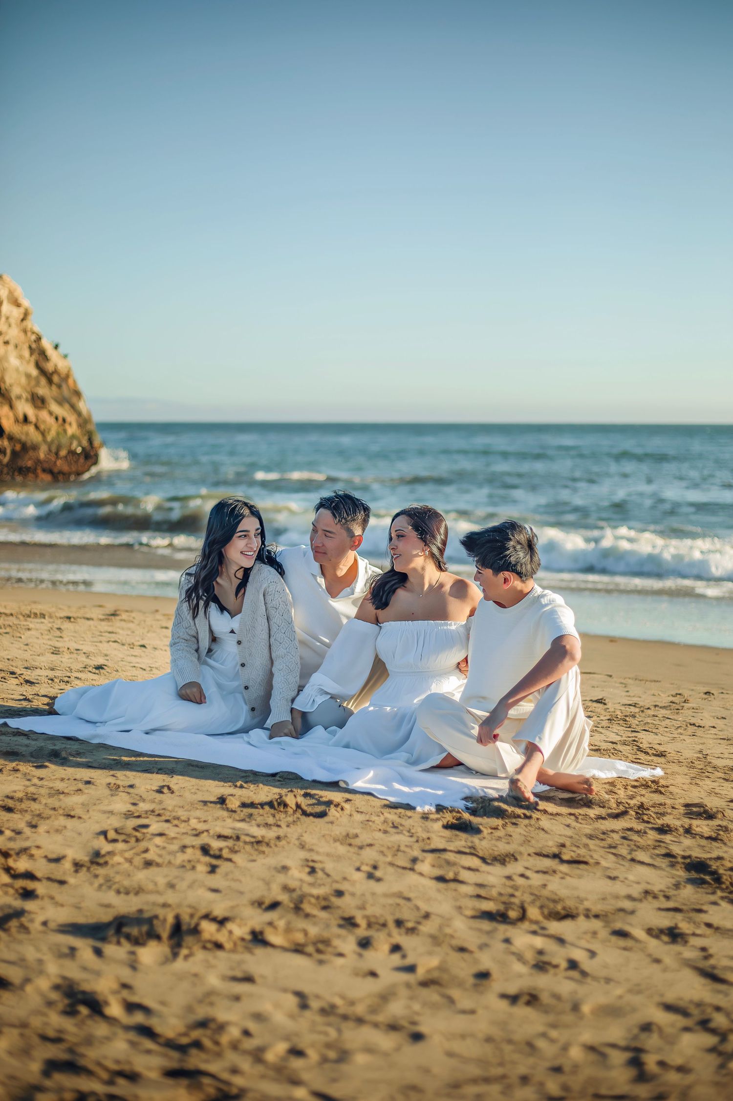 Family enjoying at the beach in Santa Cruz, captured in natural light with candid moments, ocean views, and a relaxed coastal setting