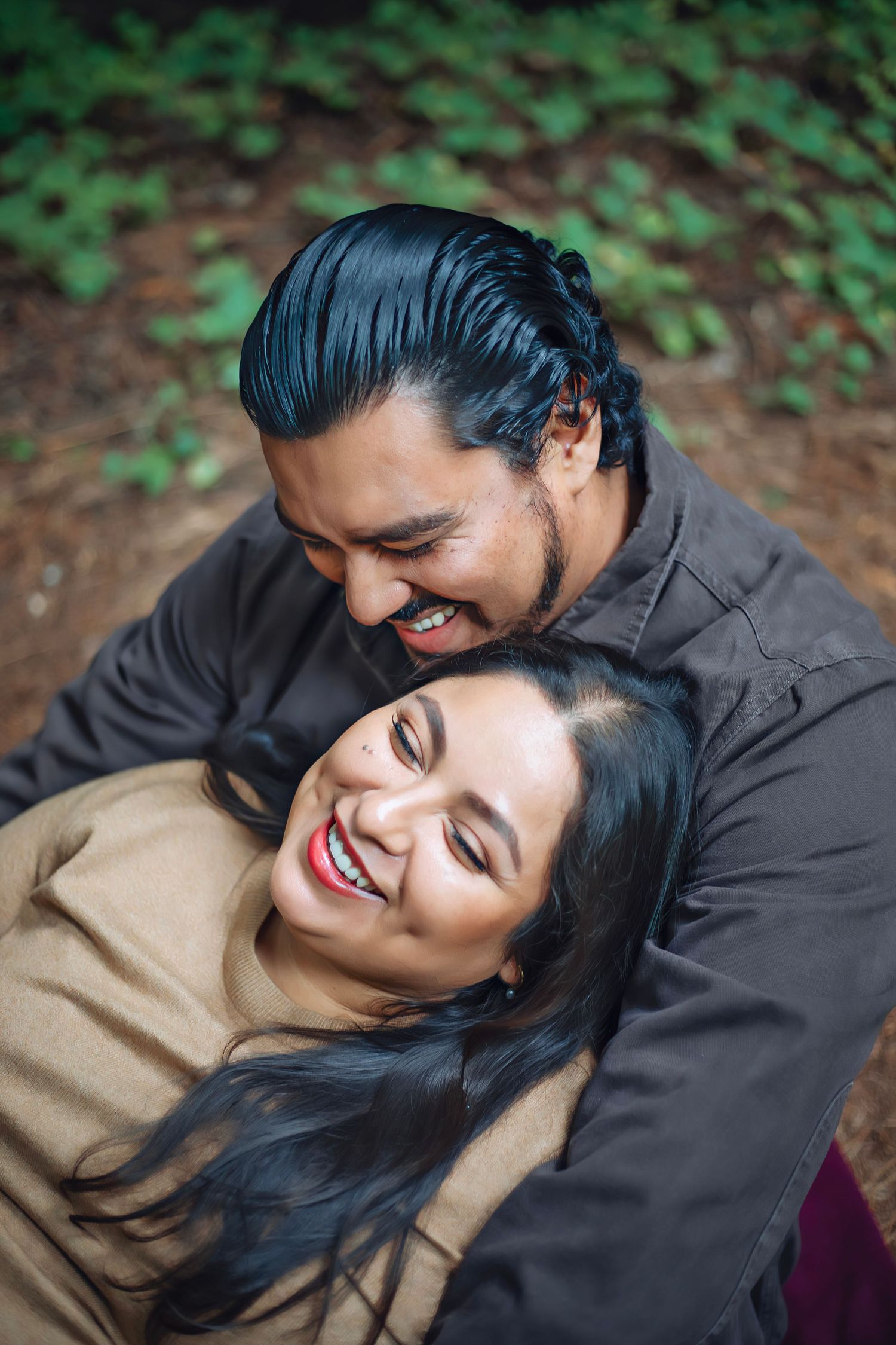A couple in the Santa Cruz redwoods, in natural light with intimate, candid moments among towering trees