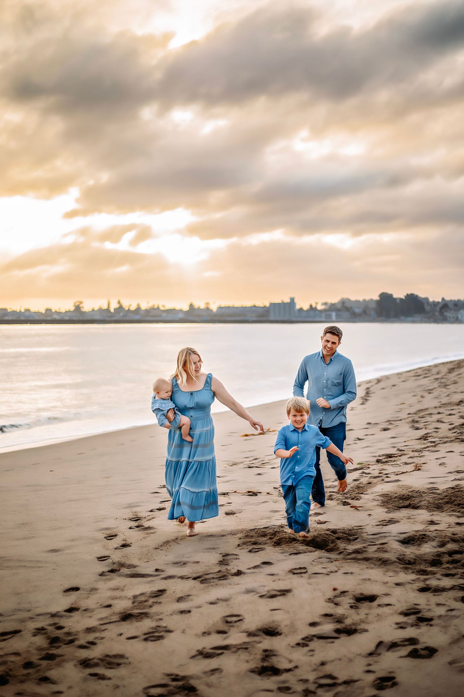 Family enjoying at the beach in Santa Cruz, captured in natural light with candid moments, ocean views, and a relaxed coastal setting