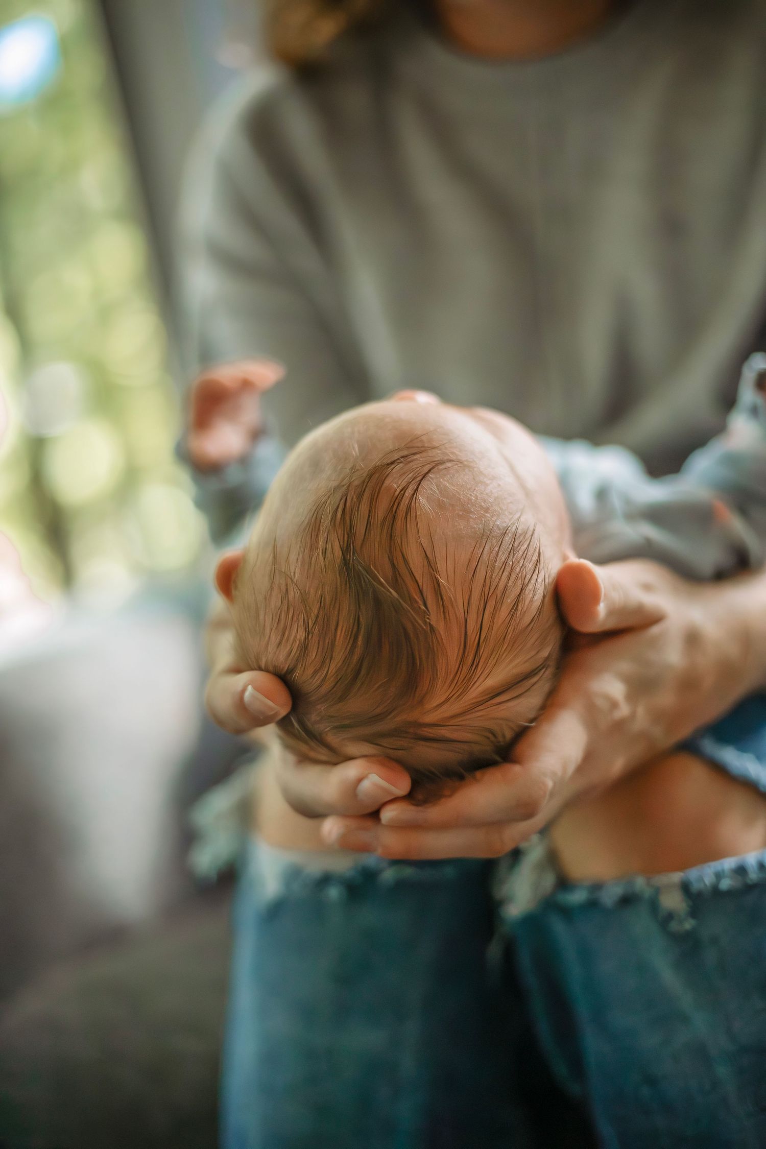 At-home newborn photo session in Santa Cruz, capturing a family’s intimate, candid moments with warmth and heartfelt connection