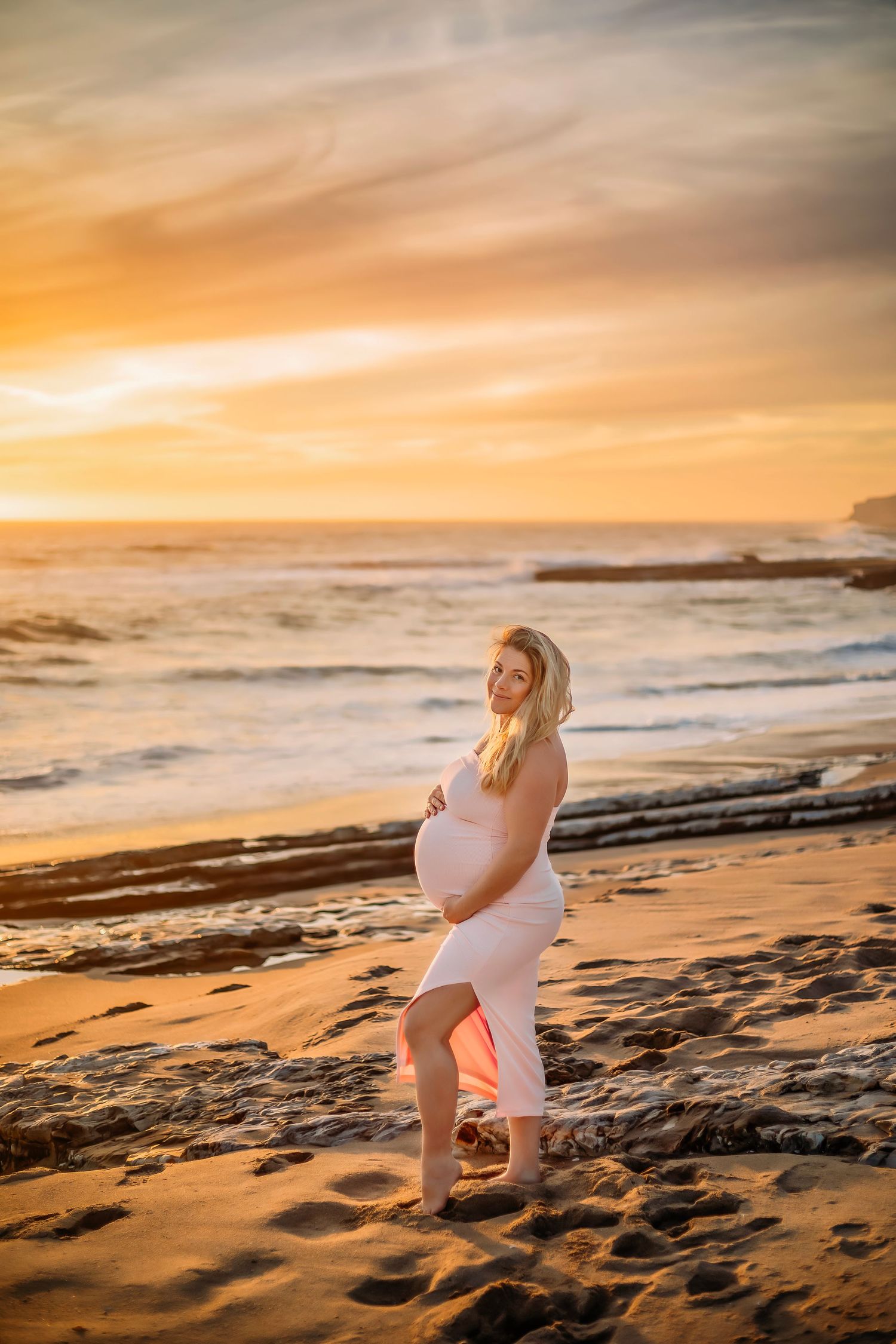 A maternity portrait on the Santa Cruz coast at sunset